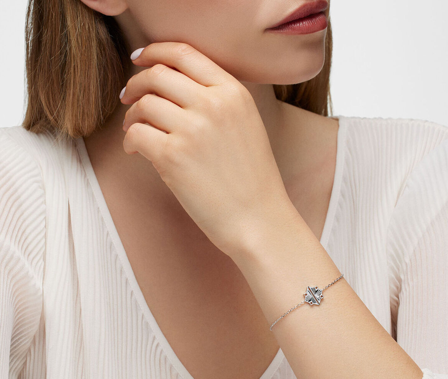 A woman wearing a Birks Muse silver bracelet.